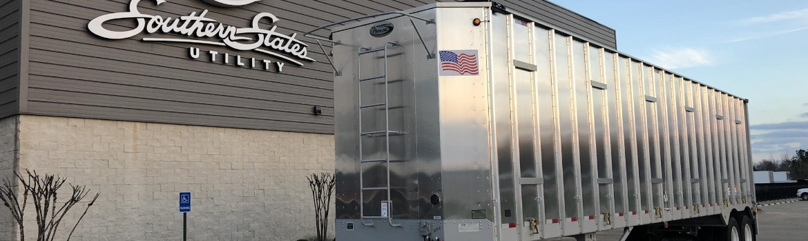 2019 Peerless Chip Trailer parked outside a building