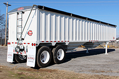 Rear and side view of a grain trailer parked in a lot