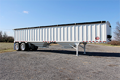 Sideview of a grain trailer parked on a lot